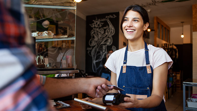 Men paying with Visa card in coffee store